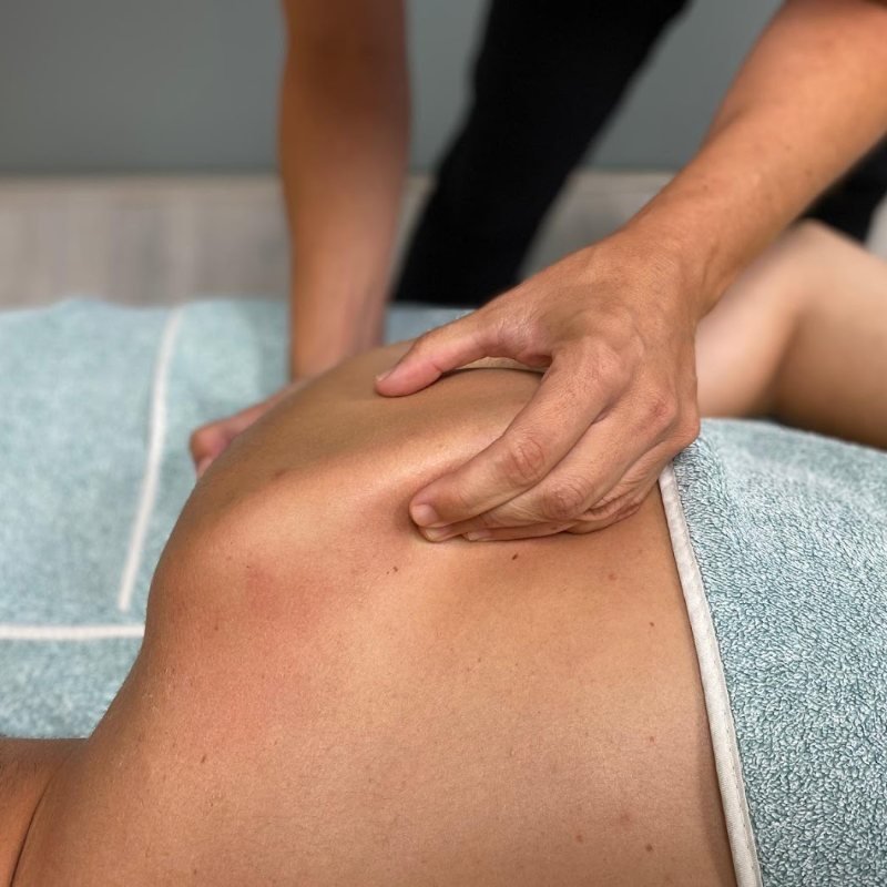 Terapia manual en la espalda en Punto Fisio, Ciudad Lineal Fisioterapeuta de Punto Fisio aplicando terapia manual sobre la espalda de un paciente en la camilla de la clínica, en Ciudad Lineal